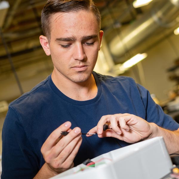 Alfonso Morera, an electrical and computer engineering senior at Rice University, wires a control box at the Oshman Engineering Design Kitchen. 