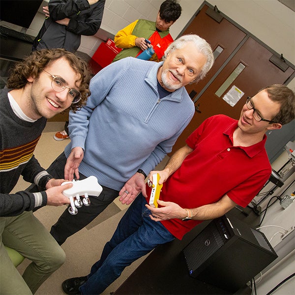 Several individuals gathered around a table, participating in a discussion.